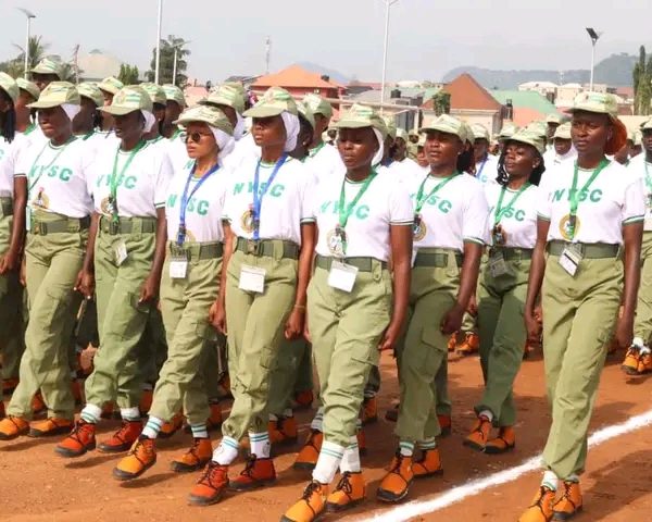 Nigerian students completing their NERD portal registration for NYSC mobilization on laptops.