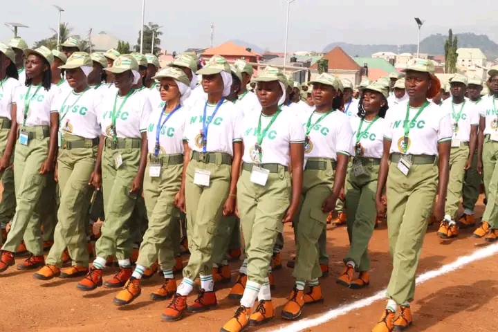 Nigerian students completing their NERD portal registration for NYSC mobilization on laptops.